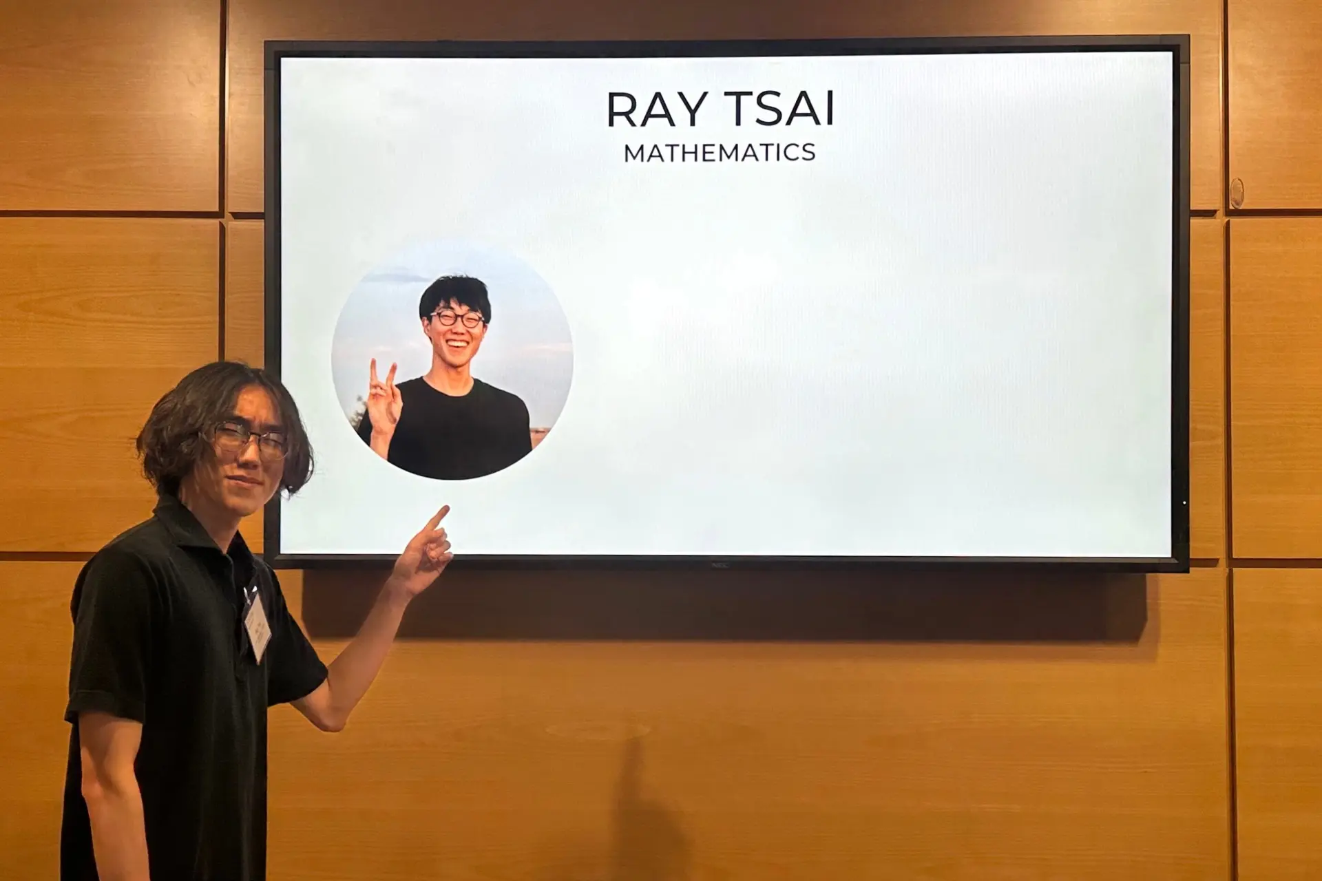 Ray Tsai pointing at presentation screen